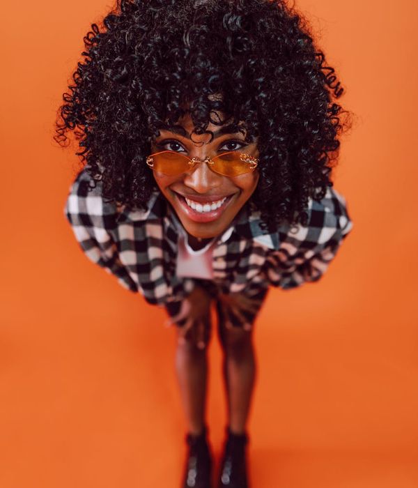 Woman in a dynamic cardio pose feeling energetic and happy.